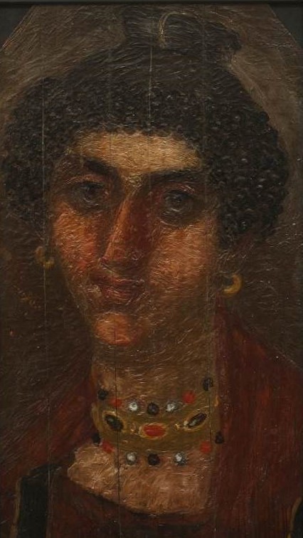 Cracked painted portrait of a woman with dark hair and eyebrows. The woman wears gold hoop earrings and a jeweled necklace with gold, red and white beads which is wrapped around her neck 3 times. She is wearing red clothes.
