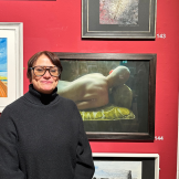 First Place winner of Art Open Exhibition stood next to their work