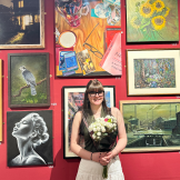 Third Place winner of Art Open Exhibition stood next to their work